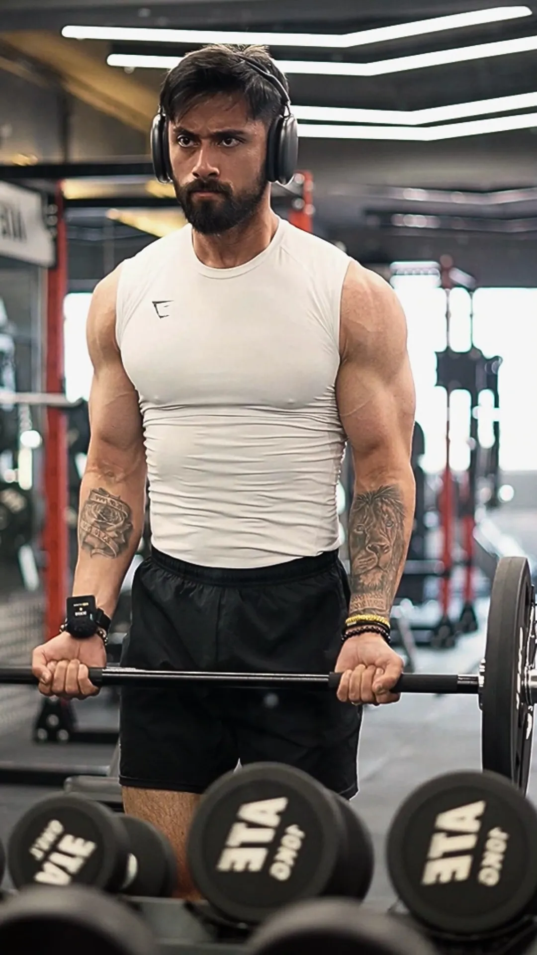 Siddharth mid-set on a barbell curl